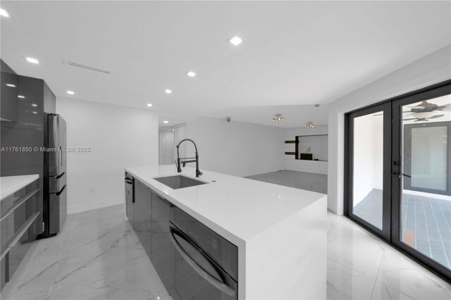15712 SW 90th Ter, Miami, FL 33196 - kitchen featuring modern cabinets, a sink, freestanding refrigerator, light marble finish flooring, and recessed lighting