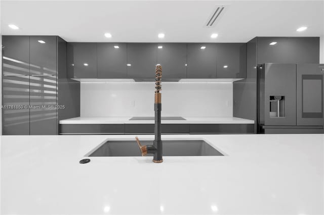 15712 SW 90th Ter, Miami, FL 33196 - kitchen with stainless steel fridge, modern cabinets, gray cabinetry, a sink, and light countertops