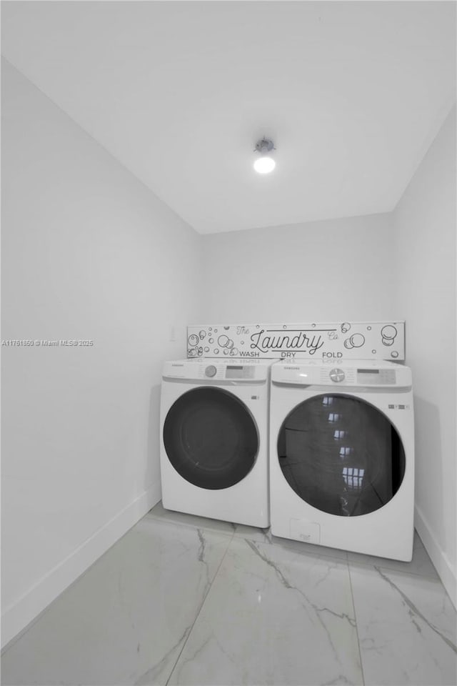 15712 SW 90th Ter, Miami, FL 33196 - washroom with washing machine and dryer, baseboards, and light marble finish floors