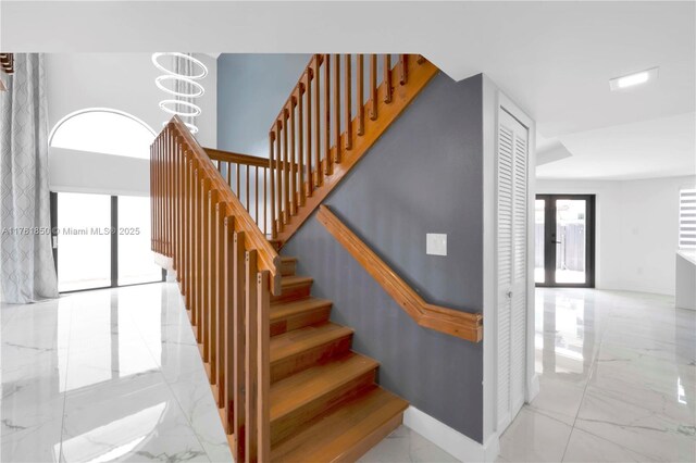 15712 SW 90th Ter, Miami, FL 33196 - stairs with marble tiled floors, baseboards, and a chandelier