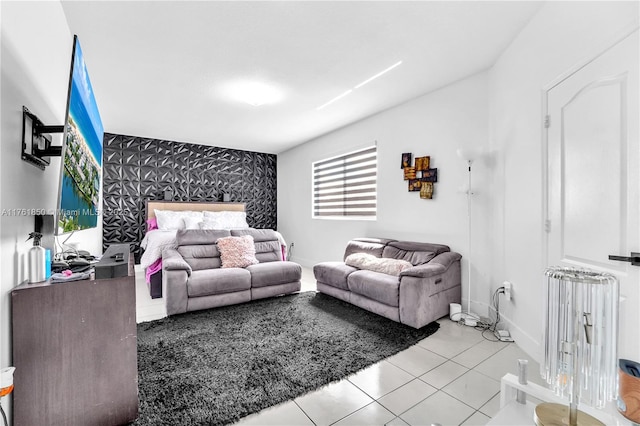 living room featuring an accent wall, radiator, baseboards, and tile patterned flooring