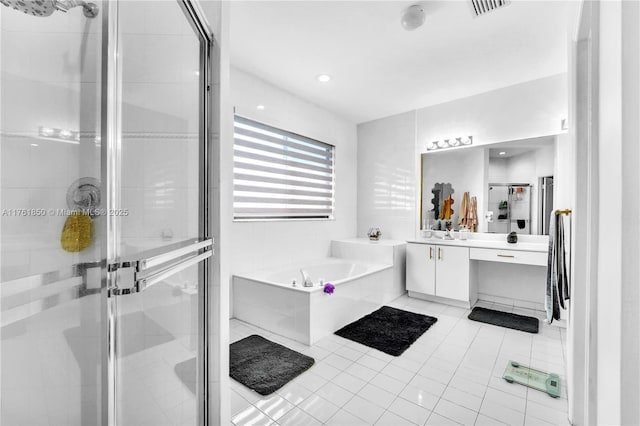 full bathroom featuring tile patterned floors, a shower stall, vanity, and a garden tub