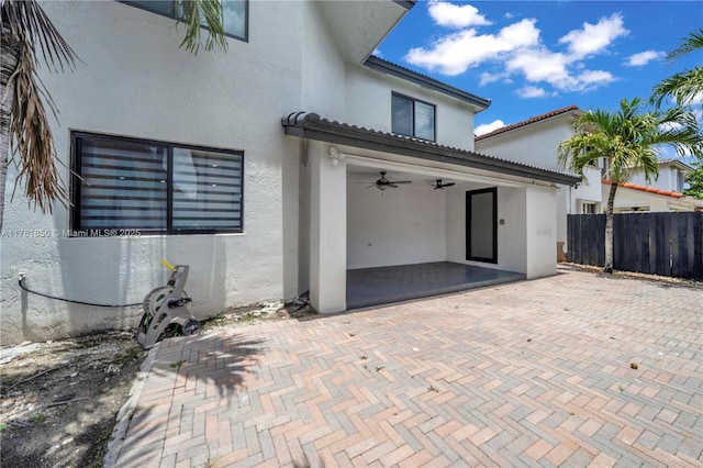 15712 SW 90th Ter, Miami, FL 33196 - rear view of property with stucco siding, fence, ceiling fan, a patio, and a tile roof