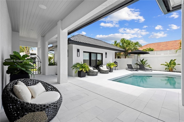 view of pool with a fenced in pool, fence, and a patio area