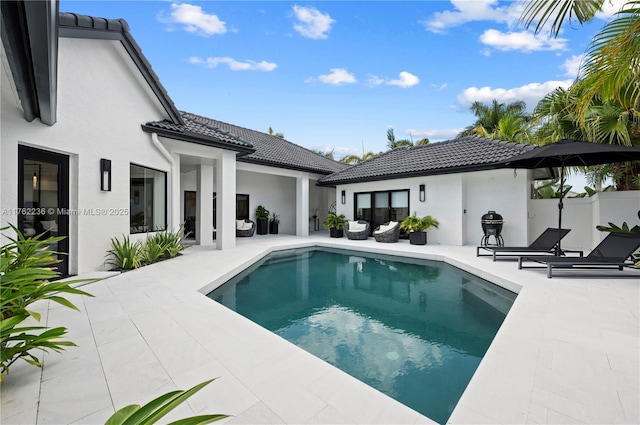 view of swimming pool with a fenced in pool and a patio area