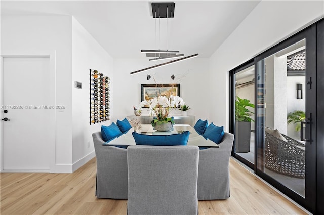 dining room with light wood-style floors and baseboards