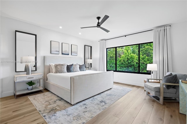 bedroom with recessed lighting, light wood-style flooring, and baseboards