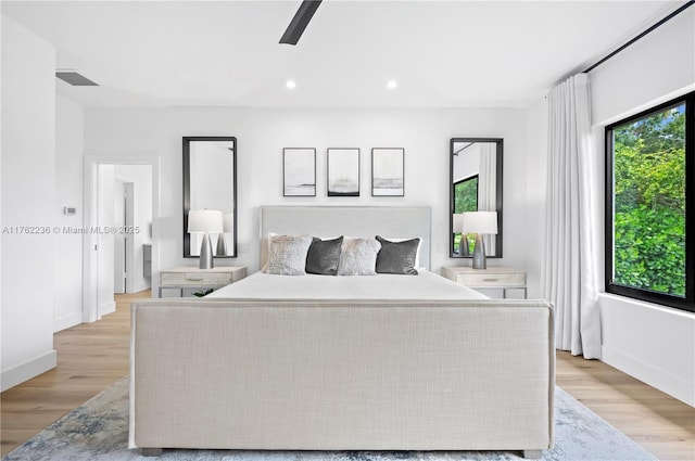 bedroom with a ceiling fan, visible vents, light wood finished floors, baseboards, and recessed lighting