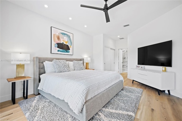 bedroom featuring ensuite bath, recessed lighting, wood finished floors, and visible vents