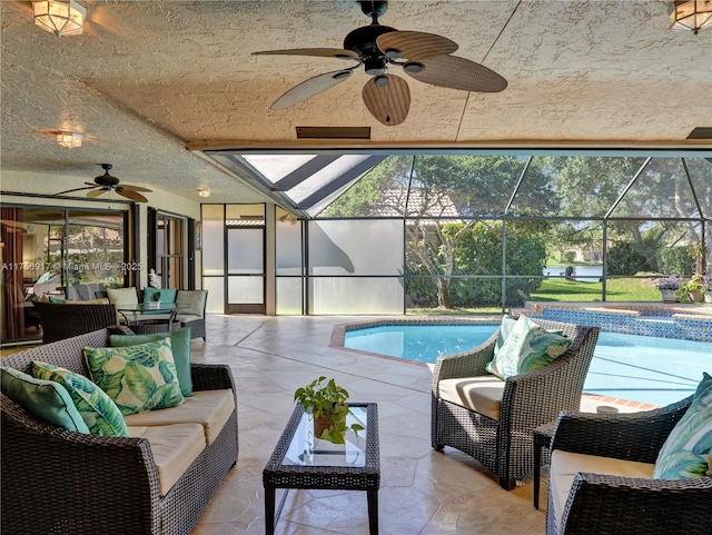 pool featuring a lanai, a patio area, and an outdoor hangout area