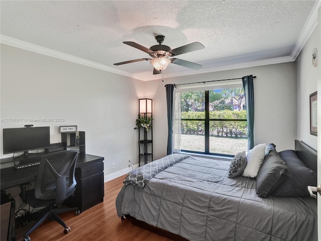 bedroom with ornamental molding, a ceiling fan, a textured ceiling, wood finished floors, and baseboards