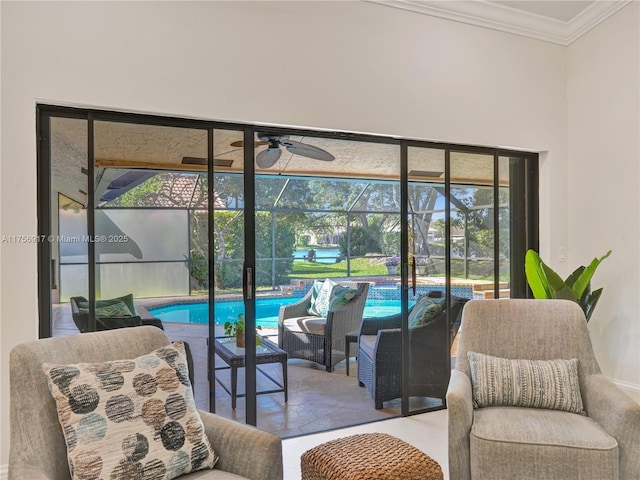 interior space featuring crown molding, a swimming pool, a ceiling fan, and a sunroom