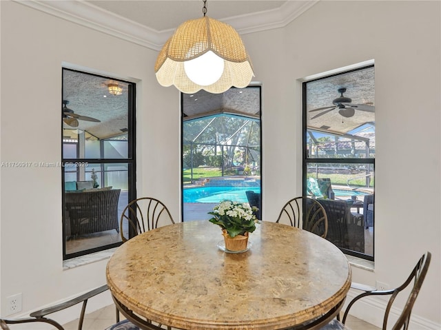 dining area featuring crown molding, a ceiling fan, and a sunroom