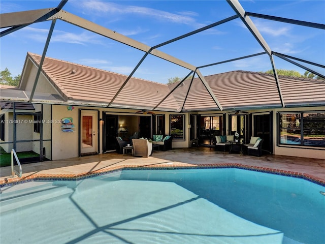 pool featuring outdoor lounge area, a patio, and glass enclosure