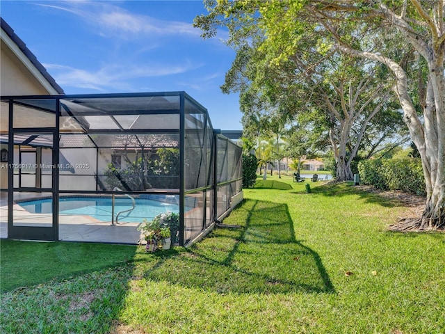 pool with glass enclosure and a yard