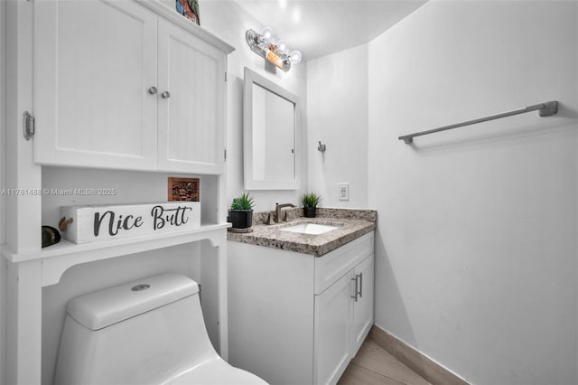 bathroom featuring vanity, toilet, and tile patterned flooring