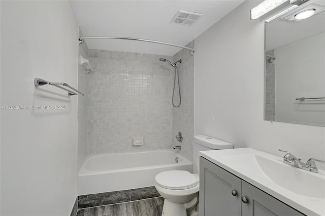 bathroom featuring vanity, bathing tub / shower combination, toilet, and visible vents