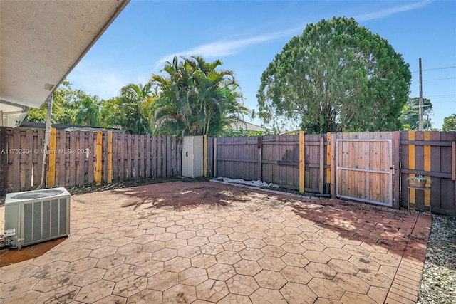 view of patio featuring a gate, cooling unit, and fence