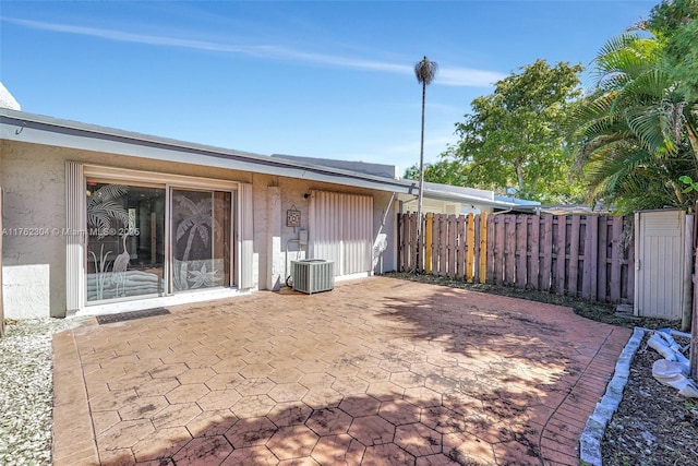 view of patio featuring cooling unit and fence