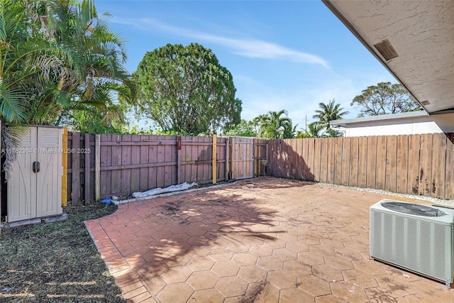 view of patio with central air condition unit and a fenced backyard