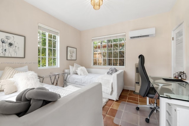 bedroom featuring tile patterned floors, baseboards, and a wall mounted air conditioner