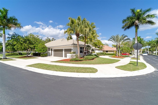 view of front of house with concrete driveway and an attached garage