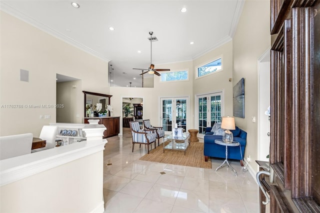 living area featuring crown molding, a high ceiling, french doors, and ceiling fan