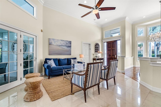 living area with a wealth of natural light, baseboards, and ornamental molding