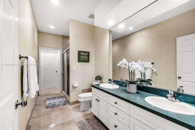 full bath with visible vents, a stall shower, toilet, and a sink