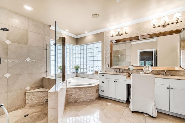 bathroom featuring tile patterned floors, crown molding, a garden tub, and a sink