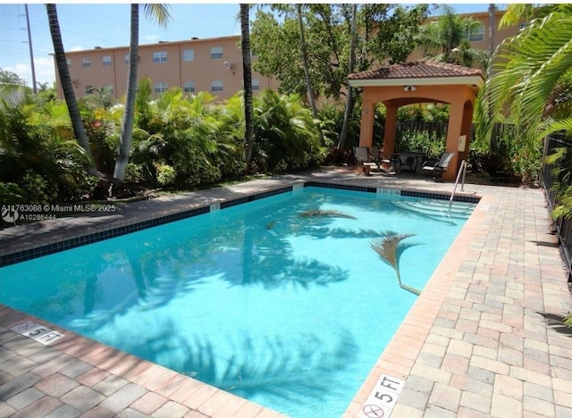 pool featuring a gazebo and a patio