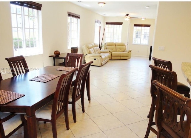 dining area featuring light tile patterned flooring and ceiling fan