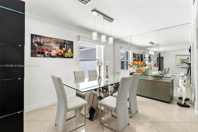 dining space featuring light tile patterned floors, visible vents, baseboards, and ornamental molding