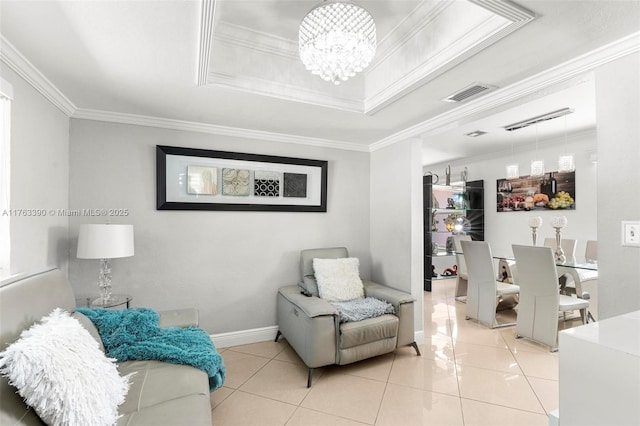 living area with visible vents, crown molding, and a tray ceiling