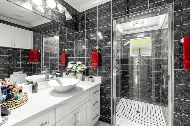 full bath with a stall shower, tile walls, ornamental molding, and vanity