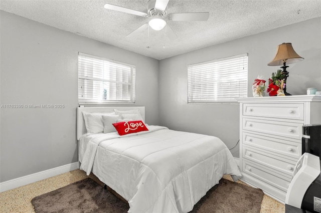 bedroom featuring speckled floor, baseboards, a textured ceiling, and ceiling fan