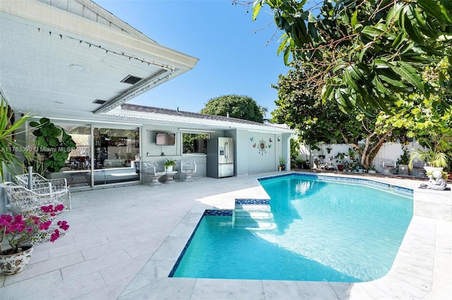 view of swimming pool featuring a patio area, a fenced in pool, and a fenced backyard