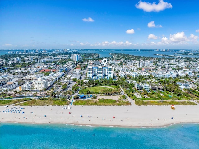 birds eye view of property featuring a water view, a city view, and a beach view