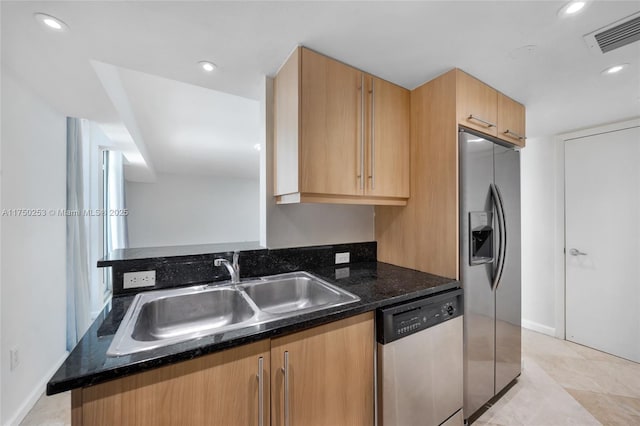 kitchen featuring visible vents, a sink, dark stone countertops, recessed lighting, and appliances with stainless steel finishes