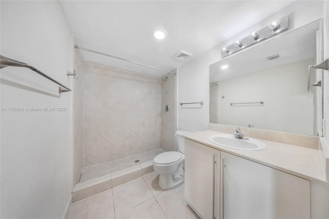 full bath featuring visible vents, toilet, tiled shower, tile patterned floors, and vanity