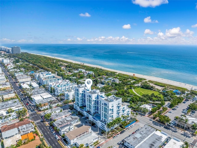 drone / aerial view with a city view, a beach view, and a water view