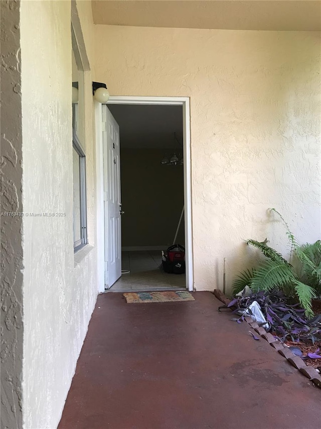 doorway to property with stucco siding