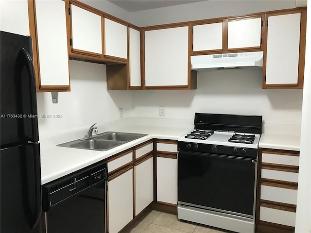 kitchen with under cabinet range hood, black appliances, light countertops, and a sink