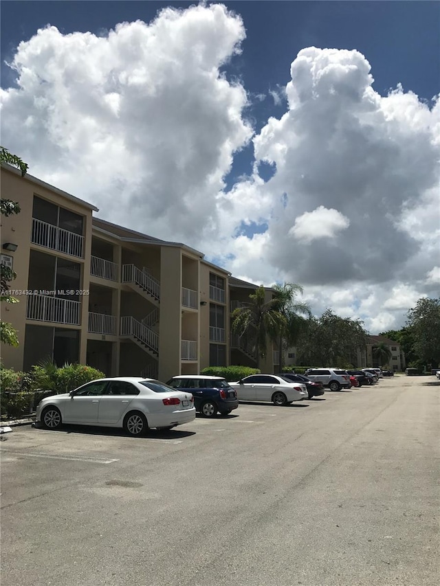 view of building exterior featuring uncovered parking