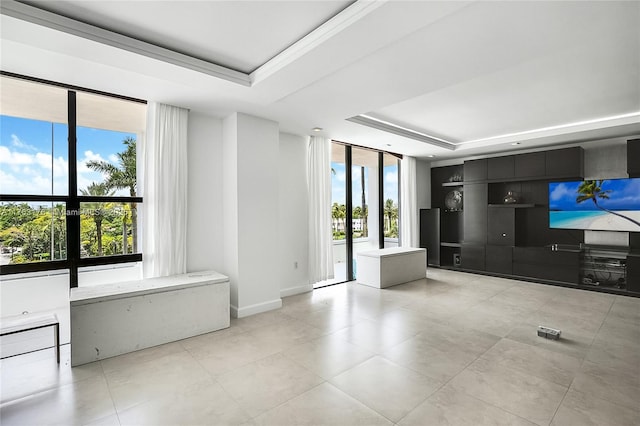 9801 Collins Ave Unit 5M, Bal Harbour, FL 33154 - unfurnished living room featuring a tray ceiling, light tile patterned floors, and floor to ceiling windows