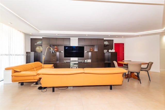living room featuring light tile patterned flooring, a tray ceiling, and recessed lighting