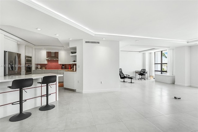 9801 Collins Ave Unit 5M, Bal Harbour, FL 33154 - kitchen with stainless steel appliances, a breakfast bar, light countertops, white cabinets, and light tile patterned flooring