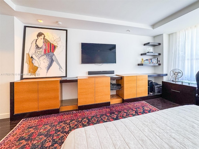 bedroom featuring built in study area and dark wood-type flooring