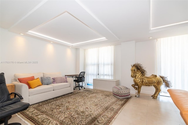 tiled living room featuring a tray ceiling