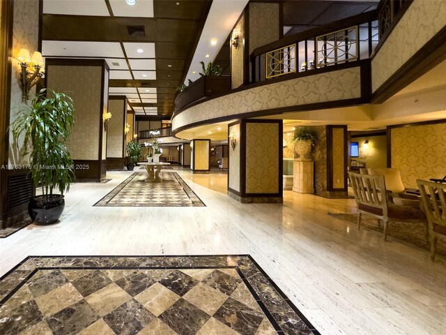 9801 Collins Ave Unit 5M, Bal Harbour, FL 33154 - community lobby featuring a towering ceiling, recessed lighting, and wallpapered walls